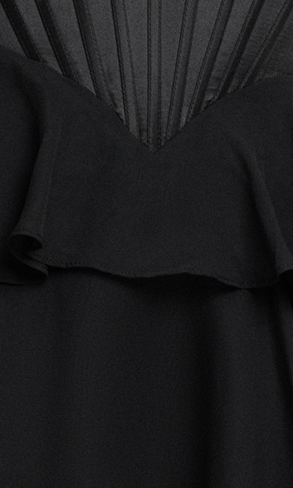 Close-up of the Ruffled Mini Hoco Dress: Blondie Nites 6222BN—a black corset mini dress with a ruffled layer and fan-patterned vertical stitched lines at the top.
